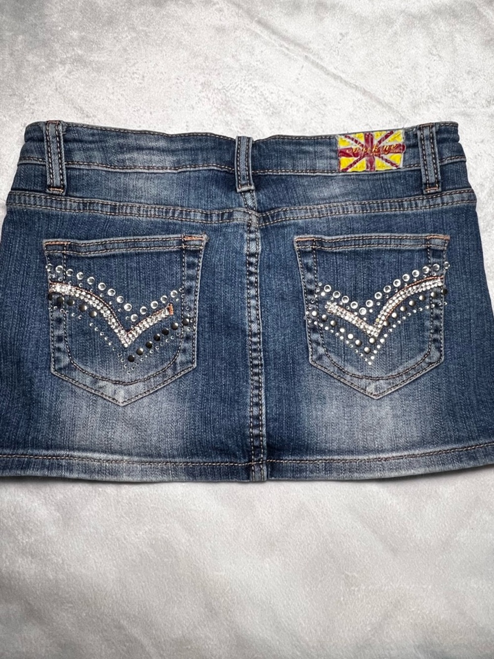 Machine Y2K Distressed Denim Mini Skirt with Studded Pockets